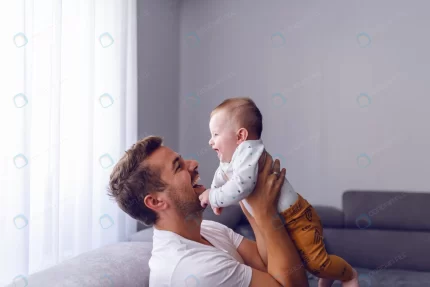 caucasian young dad lifting his loving baby boy w crcf4684a24 size10.58mb 7241x4828 - title:graphic home - اورچین فایل - format: - sku: - keywords: p_id:353984