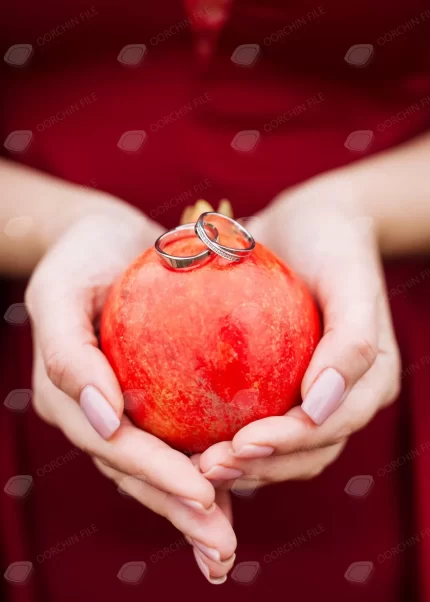 closeup woman holding pomegranate with wedding ri crc29a699c6 size6.54mb 3840x5376 - title:graphic home - اورچین فایل - format: - sku: - keywords: p_id:353984