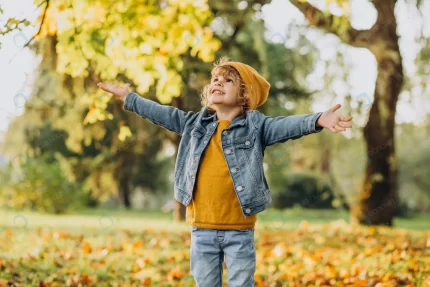 cute boy playing with leaves autumn park crc0f9c15b3 size4.42mb 3400x2267 - title:graphic home - اورچین فایل - format: - sku: - keywords: p_id:353984