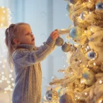 cute girl decorating christmas tree home crc4431d532 size5.3mb 4000x2667 - title:Home - اورچین فایل - format: - sku: - keywords:وکتور,موکاپ,افکت متنی,پروژه افترافکت p_id:63922