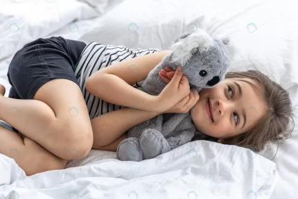 happy little girl with soft toy koala bed crc77852d28 size5.44mb 5472x3648 - title:graphic home - اورچین فایل - format: - sku: - keywords: p_id:353984