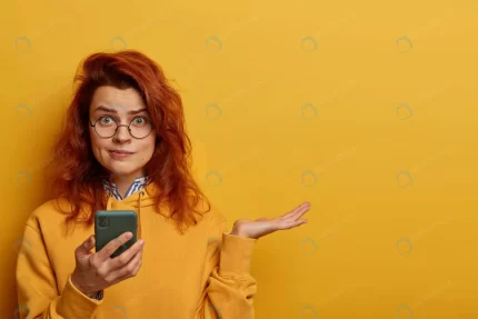 indignant puzzled redhead woman raises palm think crc52c789a1 size16.93mb 8495x5663 - title:graphic home - اورچین فایل - format: - sku: - keywords: p_id:353984