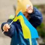patriotic little boy holds ukrainian flag stand wi rnd971 frp31930723 - title:Home - اورچین فایل - format: - sku: - keywords:وکتور,موکاپ,افکت متنی,پروژه افترافکت p_id:63922