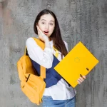 - photo young woman with yellow backpack standing w crc033c4000 size15.54mb 6720x4480 - Home