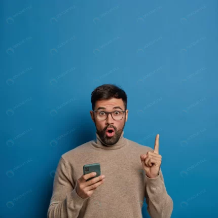surprised unshaven man holds phone shows empty sp crcd47e7704 size18.29mb 8495x8495 - title:graphic home - اورچین فایل - format: - sku: - keywords: p_id:353984
