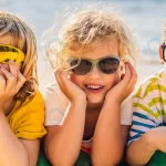 three blond kids sunglasses are lying beach banne crc3995e939 size4.45mb 6000x2000 - title:Home - اورچین فایل - format: - sku: - keywords:وکتور,موکاپ,افکت متنی,پروژه افترافکت p_id:63922