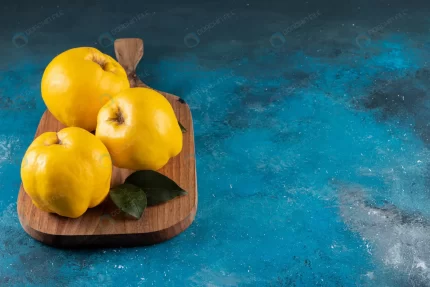 three yellow quince fruits placed wooden board crcbe71f83e size15.13mb 6000x4000 1 - title:graphic home - اورچین فایل - format: - sku: - keywords: p_id:353984