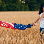 woman with american flag wheat field sunset rnd913 frp9671972 - title:Home - اورچین فایل - format: - sku: - keywords:وکتور,موکاپ,افکت متنی,پروژه افترافکت p_id:63922