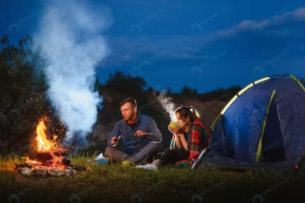 young couple having rest bonfire beside camp blue rnd346 frp9150168 - title:graphic home - اورچین فایل - format: - sku: - keywords: p_id:353984