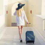- young female traveler with suitcase territory hote rnd877 frp27099446 - Home