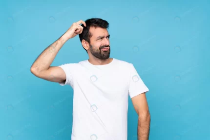 young man with beard having doubts while scratchi crc9730ec21 size0.11mb 1920x1281 - title:graphic home - اورچین فایل - format: - sku: - keywords: p_id:353984