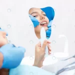 - young women checks her teeth mirror new dental im crc5b0b57c4 size4.61mb 4550x3033 - Home